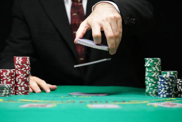 Man shuffling cards at poker table